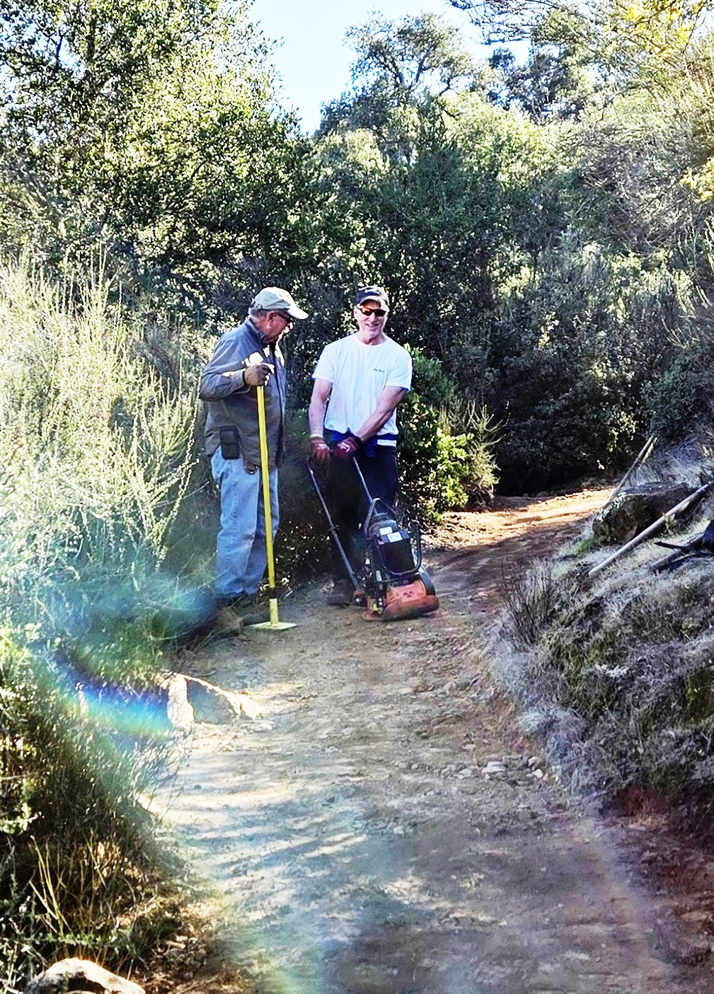 Cory and Jeff packing the trail with the vibra-plate compactor.